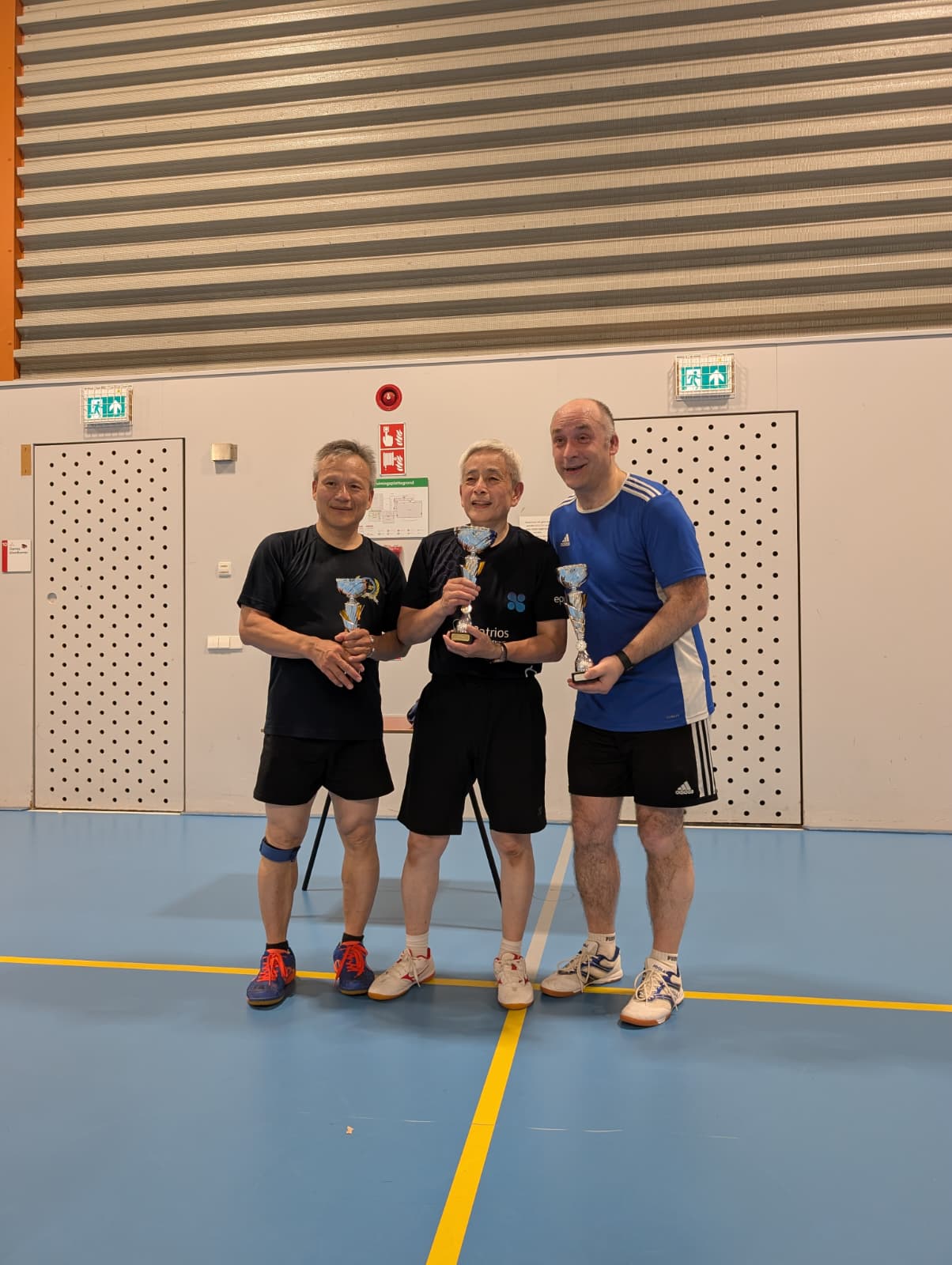Three Patrios players proudly holding their trophies after a club tournament