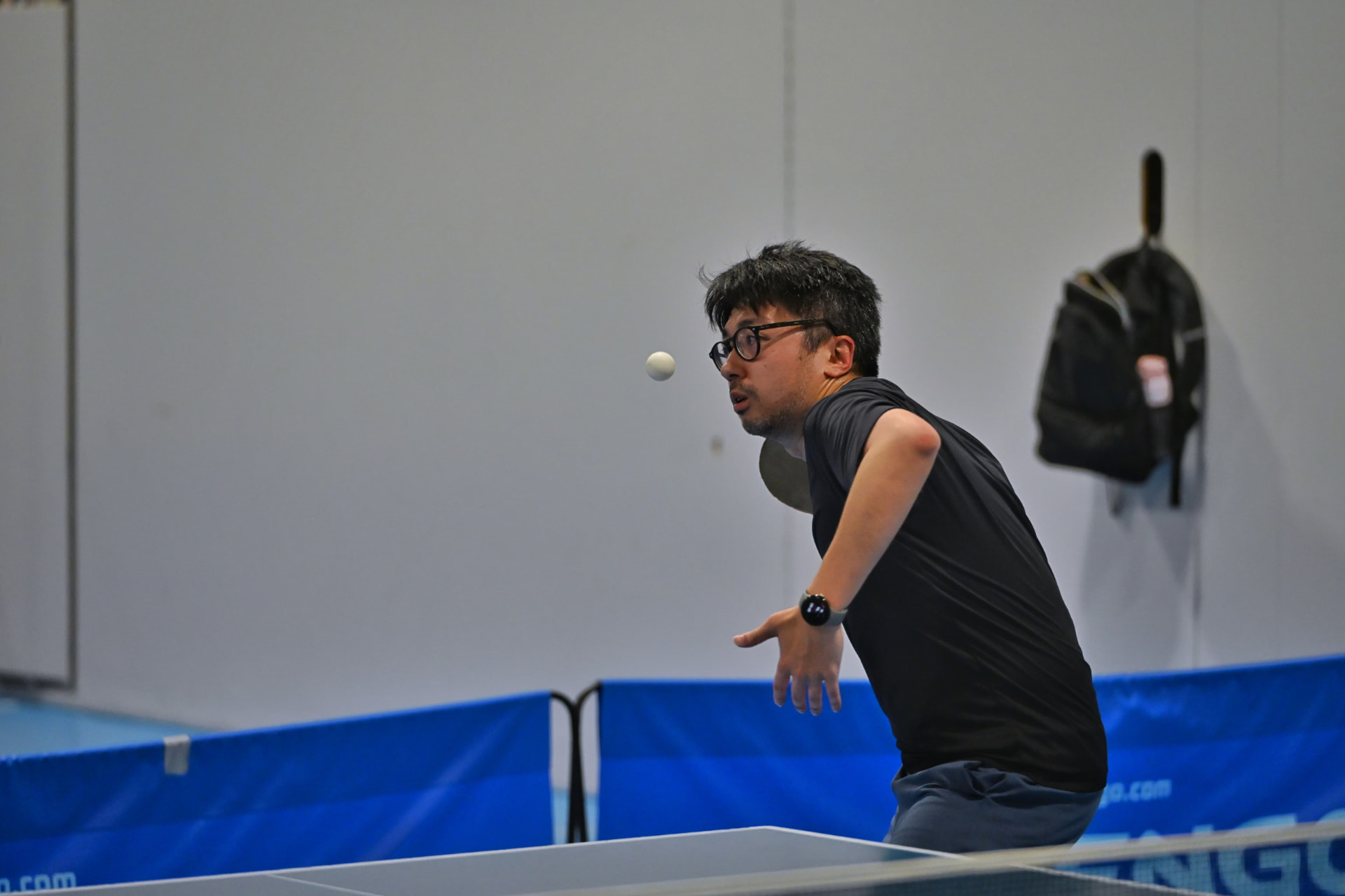 A young player keeping his eye on the ball mid-rally
